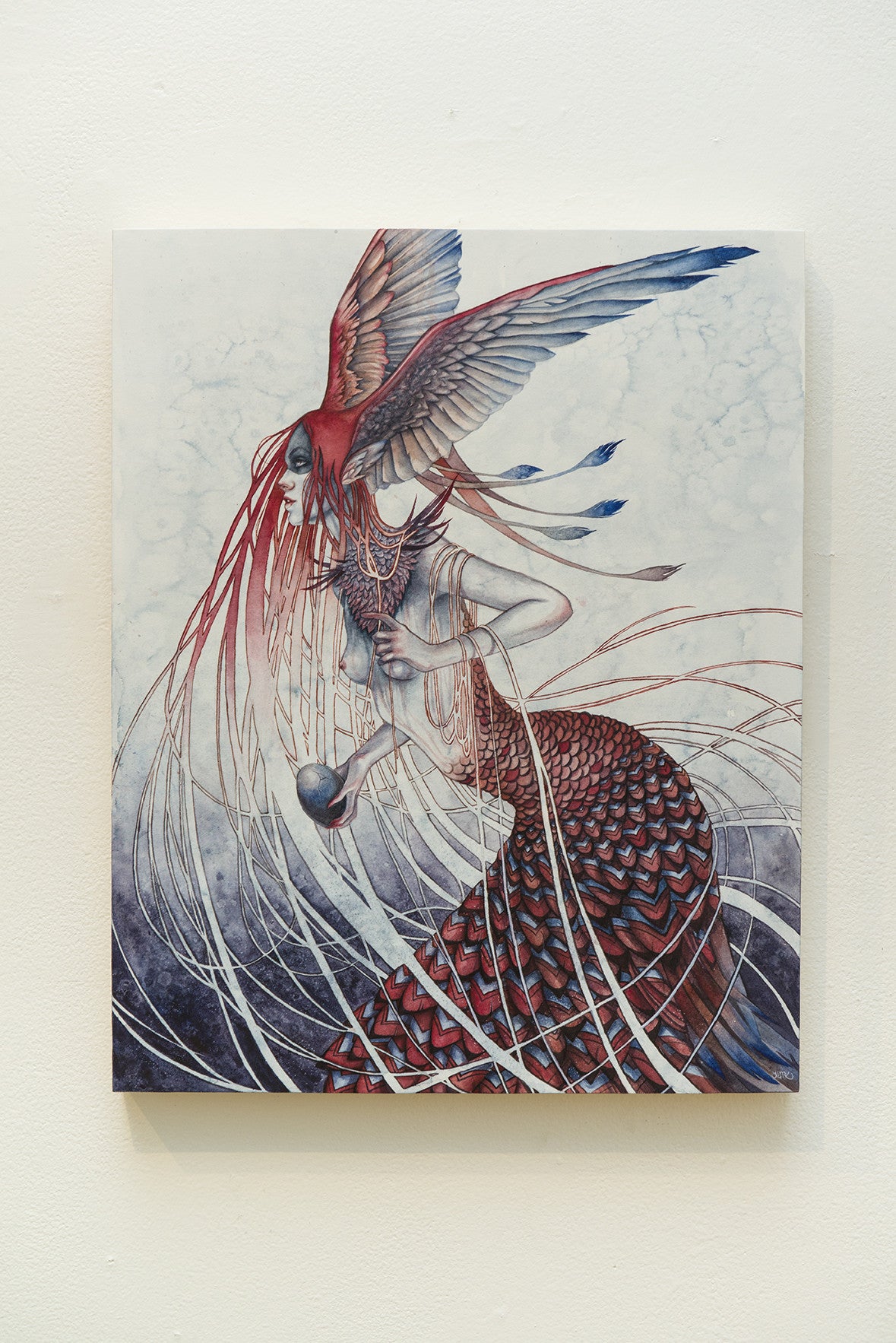 Kelly McKernans painting portrays a mythical harbinger with a human upper body, bird wings, and a fish tail. Crafted in watercolor on wood panel, it showcases flowing red and blue elements against a textured backdrop.