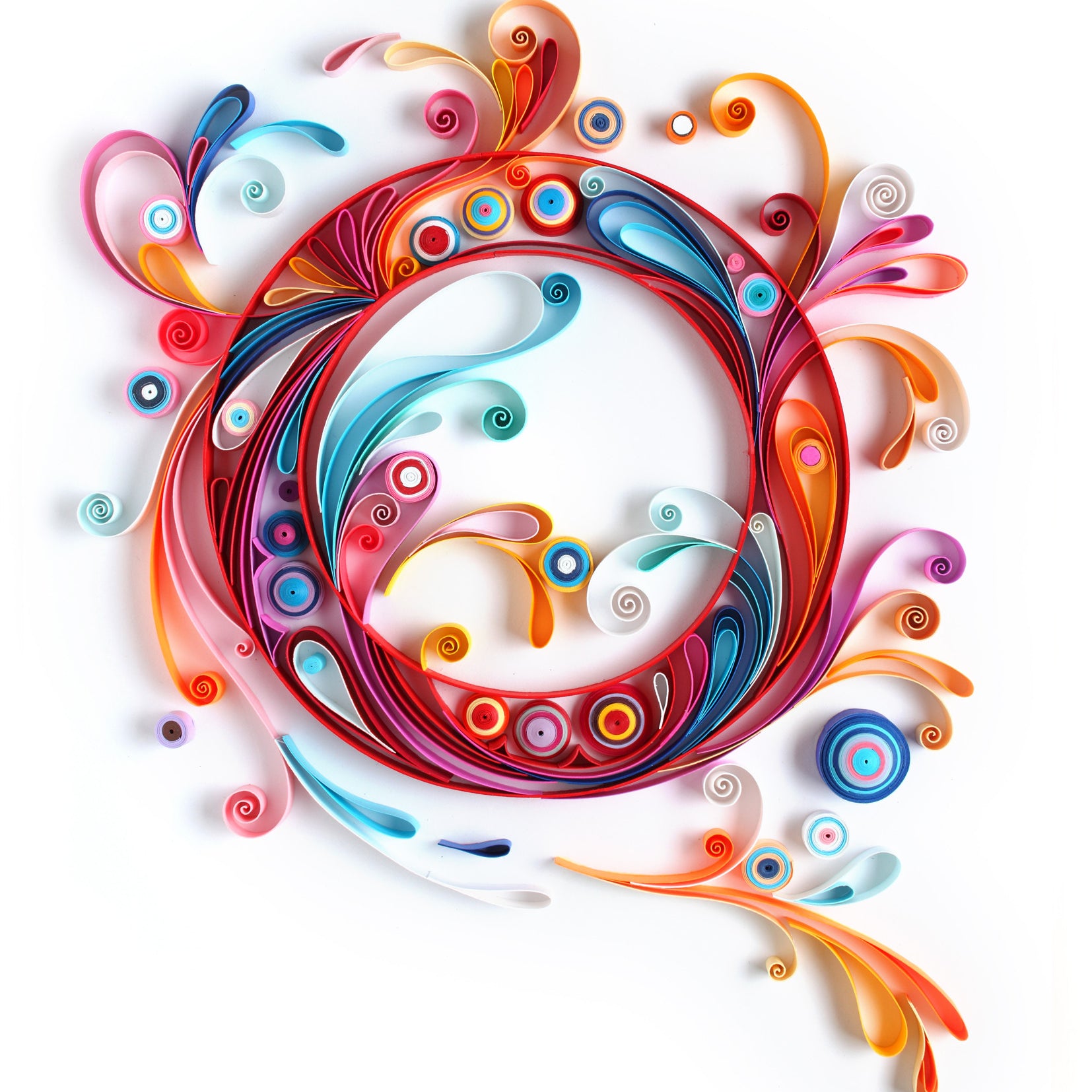 A swirling quilling circle, echoing Yulia Brodskayas style, features vibrant reds, blues, oranges, and pinks against a white background. This whimsical paper art is perfect for anyone seeking unique décor.