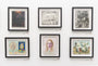 A gallery wall displays a captivating exhibit featuring six framed artworks by Miles Johnston in a grid. The pieces range from portraits to Attractor abstract designs, incorporating both color and monochrome images, each with small red labels beneath the frames.