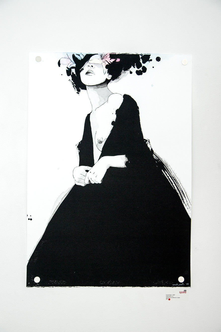 A stylized illustration of a person in a dark, voluminous dress with colorful, abstract flowers on their head captures Conrad Rosets artistic flair. This minimalist design using silkscreen and watercolor textures is offered as a limited edition under the Conrad Roset brand.