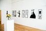 The art gallery displays minimalist black and white portraits brushed with India ink. A white pedestal with a sunflower vase takes center stage, surrounded by wooden flooring and track lighting for a bright, open atmosphere that evokes Conrad Rosets delicate style.
