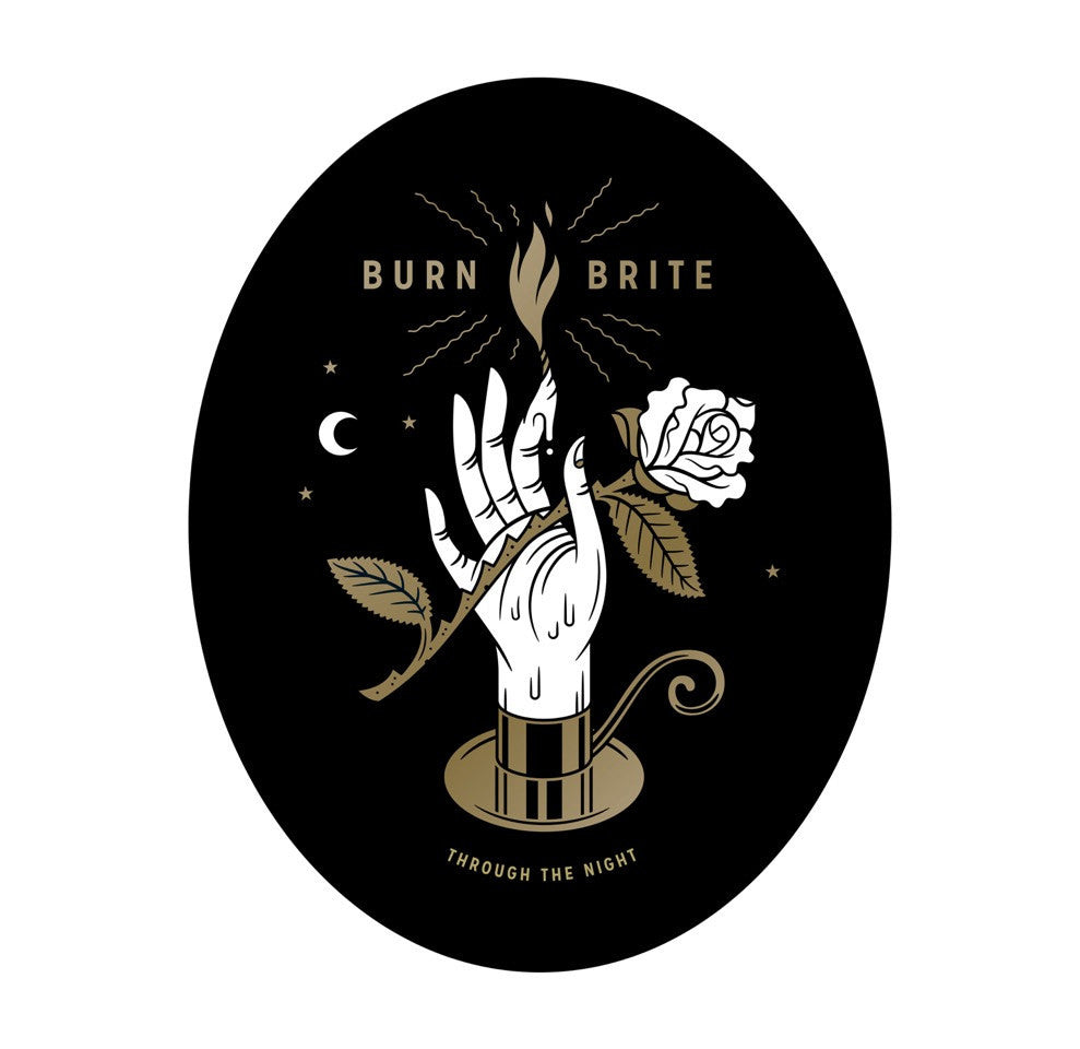 Dan Christoffersons illustration shows a hand with a burning match and white rose, BURN BRITE on top, and THROUGH THE NIGHT underneath. A black, white, and gold oval contains stars and a crescent moon. Available as an Archival Giclee Print.