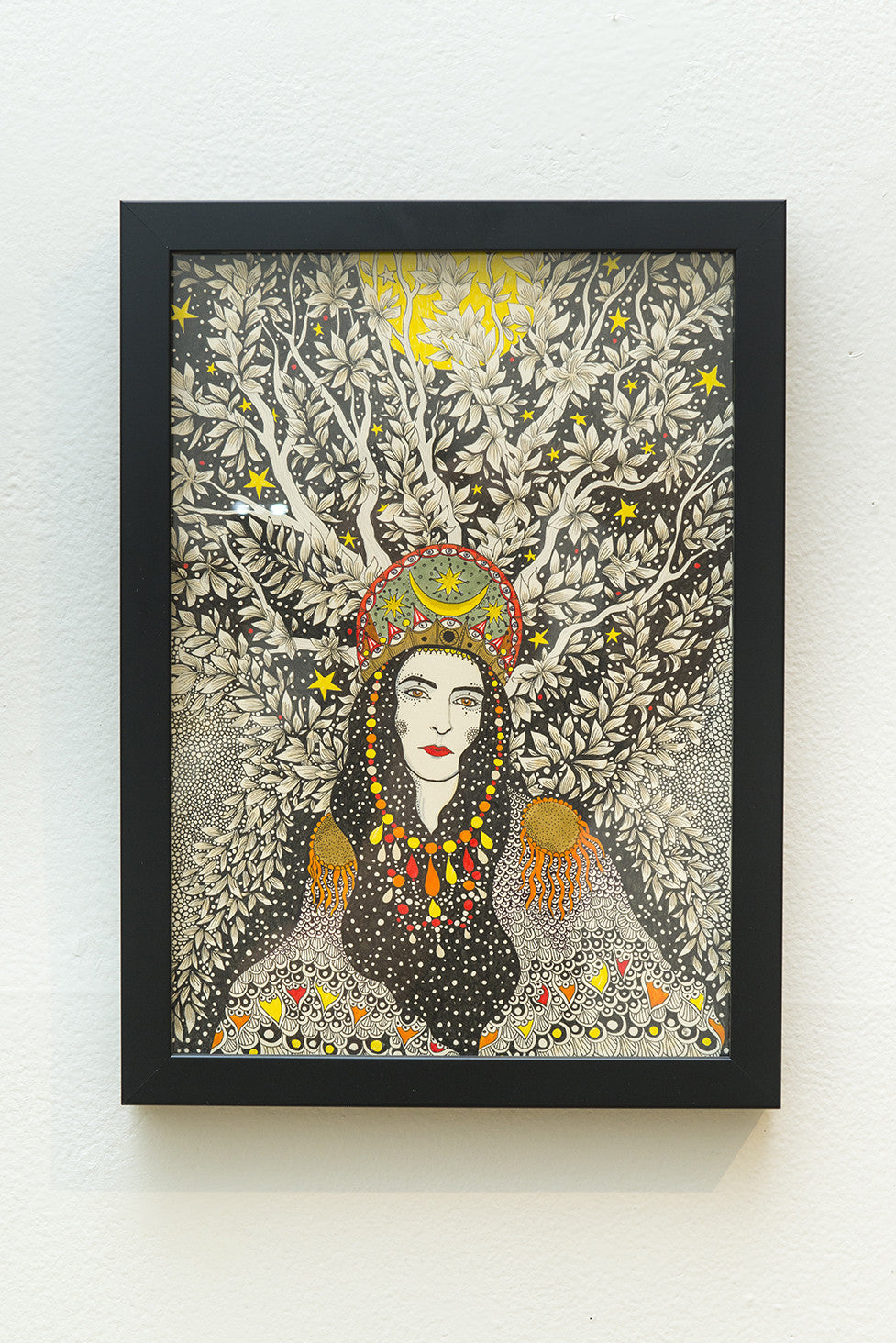 This framed illustration, inspired by Daria Hlazatovas style, features a woman with long hair in a vibrant headdress and jewelry. Its set against swirling branches and stars, blending intricate black and white designs with red and green accents.
