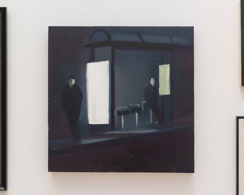 This Brett Amory-inspired oil on wood panel painting depicts a dimly lit bus stop at night with two figures in dark clothing under the shelter. Bright lights cast shadows on the ground, capturing the Supersonic Invitational ambiance.