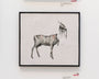 A surreal mixed media artwork by Joao Ruas showcases a deer-like creature with a goats head amid organic shapes. Its reminiscent of a Horse Study, framed and displayed on a white wall with some gallery text visible nearby.