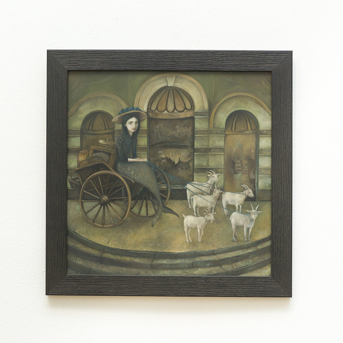 Nom Kinnear Kings Merewifs Voyage is a surreal oil painting on wood panel featuring a woman in a dress seated in a cart pulled by four goats. Set against an intricately muraled arched building facade, the piece creates an eerie atmosphere with its finely detailed depiction.