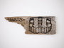 A weathered driftwood piece features a stylized painting of two faces with elongated eyes and neutral expressions, with GATS expertly burnt into the left side, blending rustic charm and urban flair.
