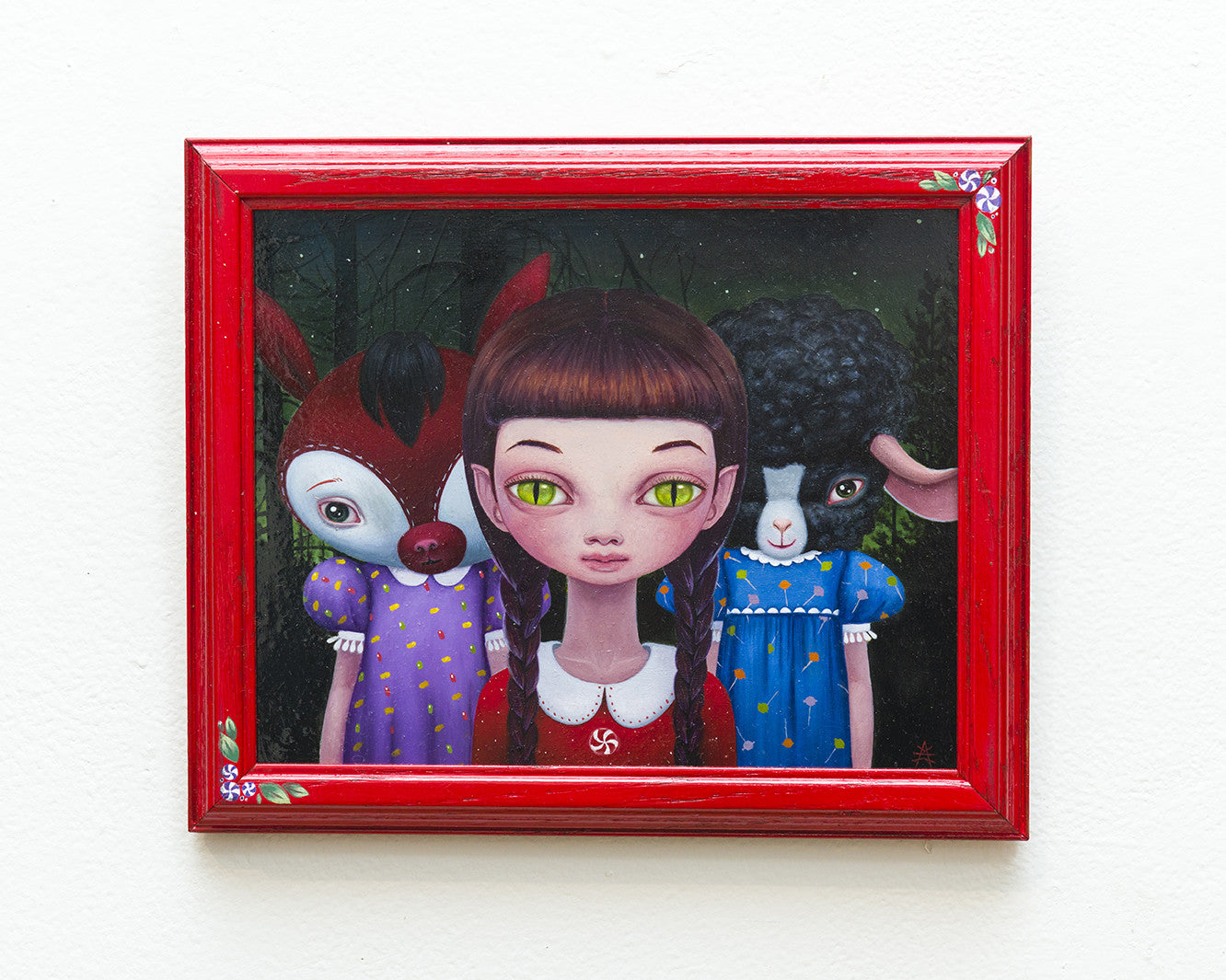 Ana Bagayans framed painting features a girl with large green eyes and bangs in a red dress, bordered in red. It includes two Trick or Treaters resembling a deer and lamb in dresses, set against a dark forest background as if oil on wood panel.