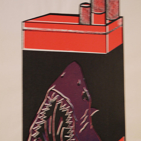 A Shark Toof cigarette pack illustration shows three cigarettes protruding, highlighted by a shark graphic with an open mouth for a warning. The hand-printed design in red, black, and white adds an edgy flair.