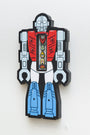In Matt Ritchies signature blocky, cartoonish style, this illustration shows a vivid red, white, and blue robot with a cutout torso revealing smaller elements inside against a plain white background.