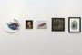 A row of five paintings by Nom Kinnear King adorns a white wall, each with distinct styles and frames. Especially captivating is the oil painting Merewifs Voyage. The collection spans from abstract portraits to vibrant fantasy scenes, including pieces on wood panels in varied themes.