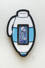 A stylized Matt Ritchie thermos features a small framed section with ballpoint pen sketches of a skull, two keys, and a bone, all tinged in blue against a plain white wall background.