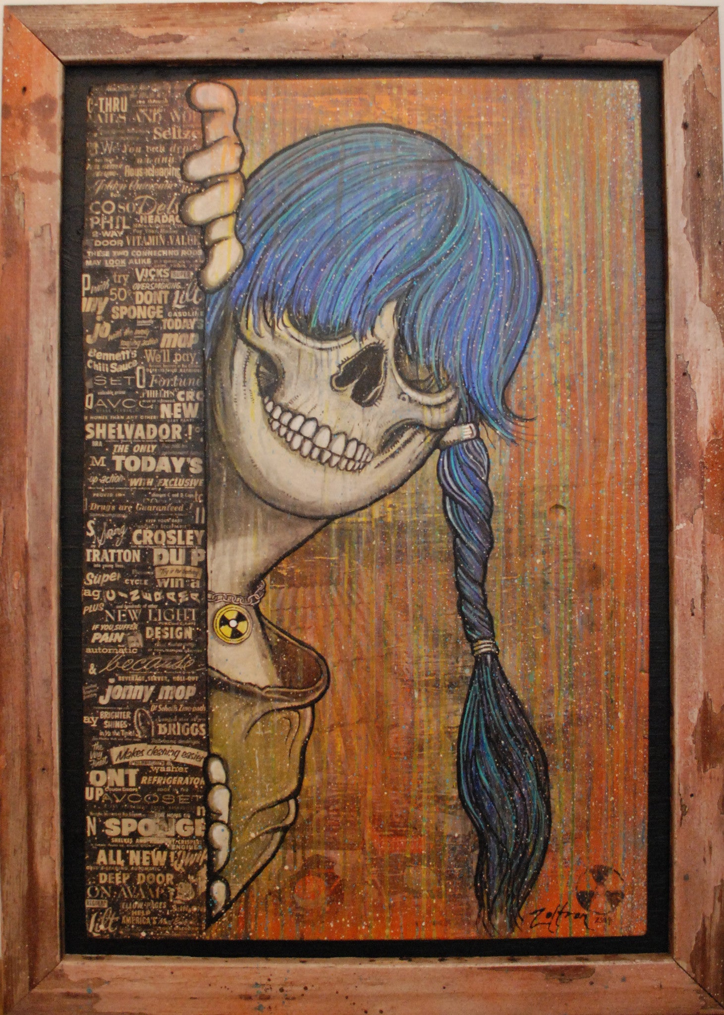 Zoltrons Sue Nami: Harbinger is a striking mixed media piece featuring a blue-braided skull, smiling behind vintage text and graphics. It wears a yellow shirt with a radioactive symbol, set against an abstract earthy-toned background.