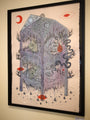 This framed artwork by Justin Lovato captures a mystical abstract shelter, featuring animal and organic elements like wolf eyes and swirling shapes in blue, gray, and red crescents. Ink on paper contrasts beautifully with the pale earth-toned background.