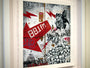 Jessica Hesss custom framed artwork features graffiti-style visuals with red lightning bolts and 88.1 FM amidst skull patterns, abstract shapes, and detailed designs in black, white, and red, echoing her dynamic gouache painting style.
