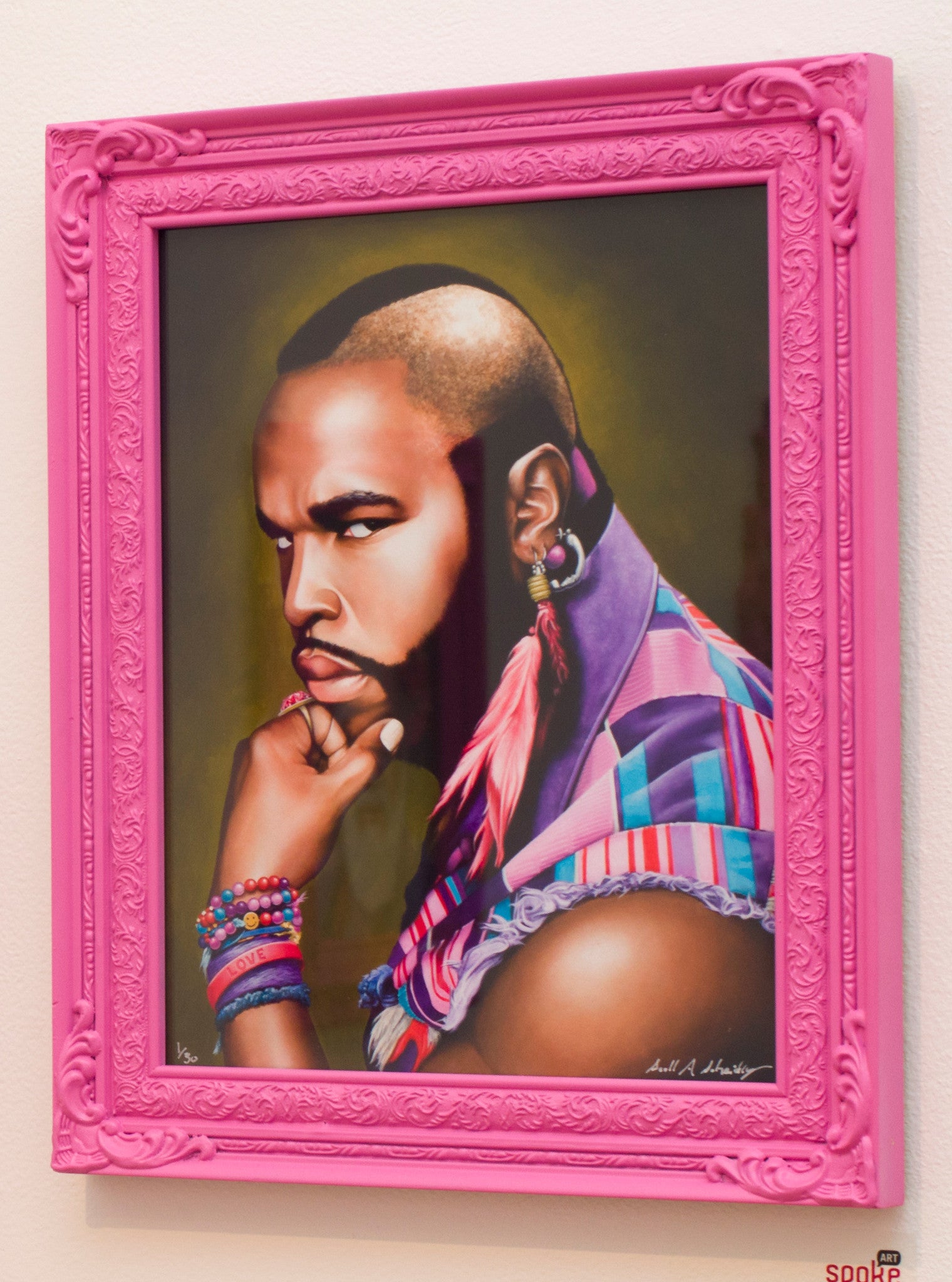 Scott Scheidlys vibrant portrait depicts a person with a mohawk, hoop earring, and colorful attire in a pink ornate frame. The subject gazes thoughtfully to the side with their chin on their fist. Available as a limited edition archival pigment print.