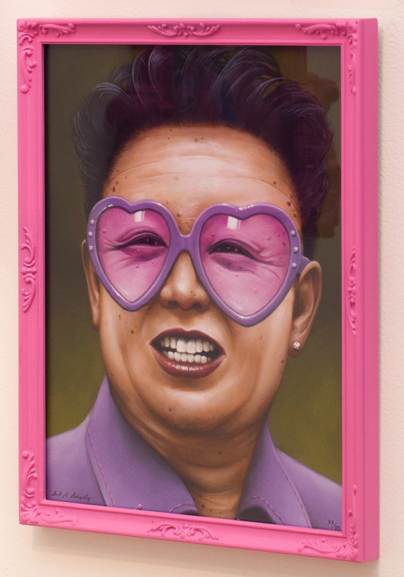 Scott Scheidlys framed painting features a man in heart-shaped pink glasses, a pink shirt, and slicked-back hair. The custom-painted pink frame highlights the vibrant colors. This fine art giclee print adds a playful touch to any room.