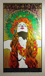 The vibrant concert poster by Chuck Sperry shows a woman with long hair, eyes closed, wearing red and orange flowers. She dons a floral necklace and a radiant green-orange crown. Widespread Panic Spring Tour 2013 is displayed at the top.