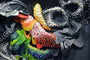This abstract art installation, by Crystal Wagner, boasts layered swirling shapes in vibrant colors like yellow, orange, and green. Black, white, and gray elements intertwine within the 3D design for a dynamic textured visual display.