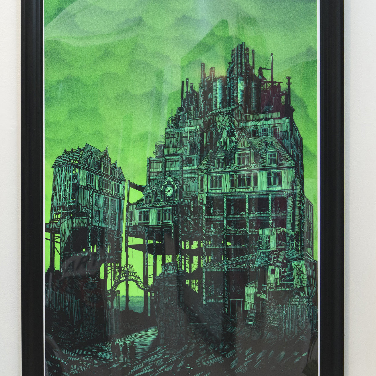 Framed artwork reminiscent of a Daniel Danger piece, showcasing a dystopian cityscape with chaotic, factory-like structures against a moody green sky. Tiny figures at the base exhibit intricate detail akin to Supersonic Invitational screen prints, all in shades of green and black.
