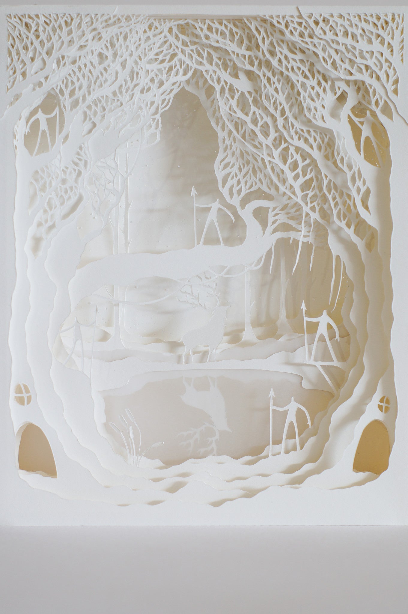 This intricate Hari & Deepti cut paper art piece features a layered forest with trees and abstract shapes, creating depth and shadow that evoke the mystery and whimsy of an enchanted landscape.