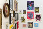 A gallery wall of cat-themed artworks, showcasing fine art giclee prints and vibrant illustrations in varied styles. Noelle McClanahans charming Stars and BUBs Forever print stands out, adding allure against the crisp white walls.