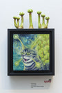 In a San Francisco gallery, David Natales Cosmic Kitty is part of the Lil Bub art exhibit. The framed artwork showcases a cat with green laser eyes against a celestial backdrop. The frame features small green sculptures resembling alien cacti and is priced at $200.