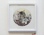 Frail Caress, a framed artwork by Kikyz1313, showcases a cat amidst fish and flowers on a textured backdrop. With intricate details, it graces a white wall, capturing the unique style celebrated at Spoke Art.