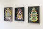 Three colorful abstract portraits by Daniel Jaffe, titled Untitled 2, hang in black frames on a white wall. Each features unique symmetrical designs and vibrant patterns, blending traditional and modern elements with slight variations in color and style.