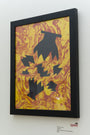 Framed abstract artwork titled Flynn De La Hoz, featuring black jagged shapes on a vibrant yellow and red hand-marbled background. Crafted with hand-cut paper, it echoes Ryan De La Hozs distinct style and is displayed on a white wall. Brand: Ryan De La Hoz.