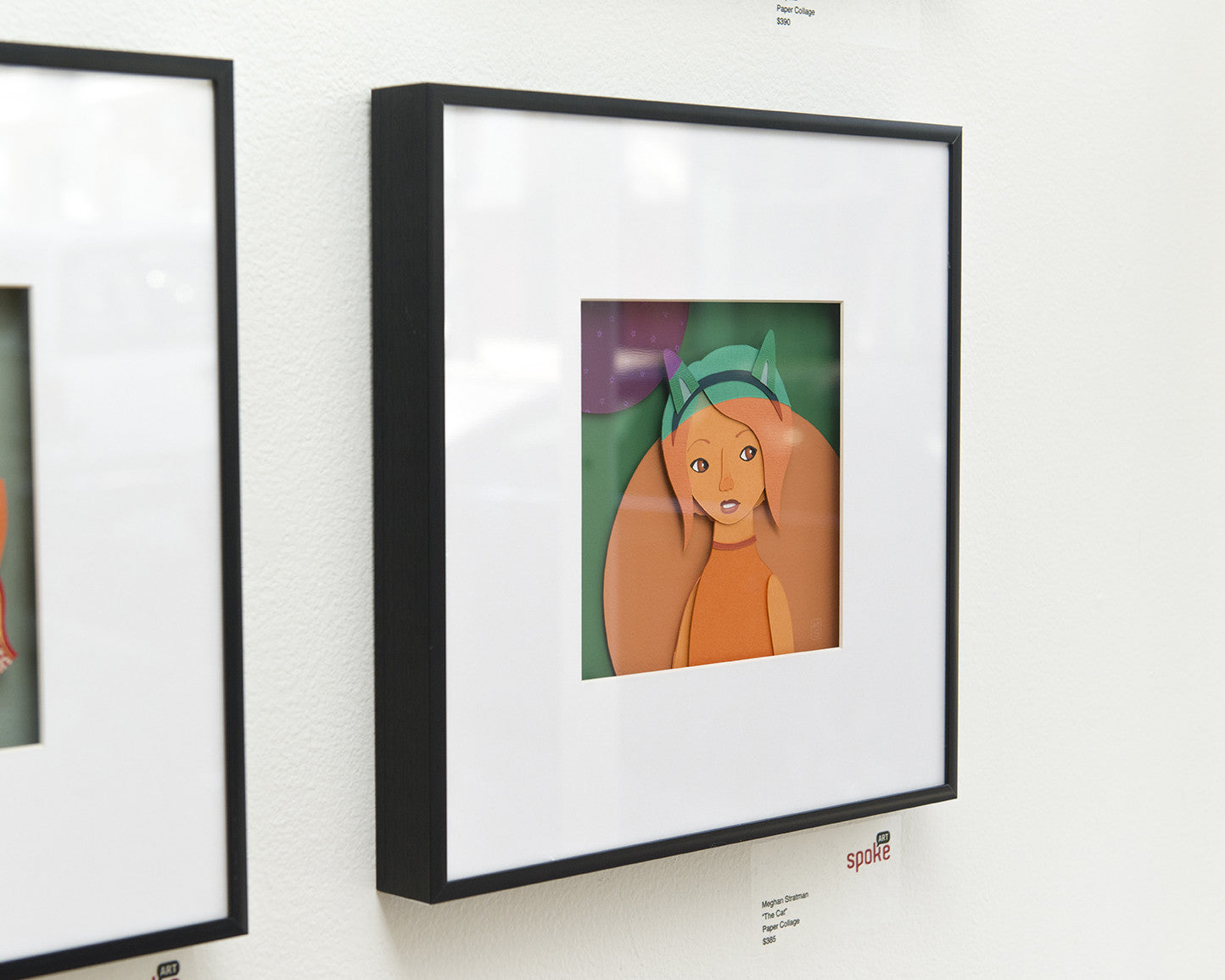 Meghan Stratmans modern framed art features a stylized illustration of a person in a green hat on a white wall. The elegant black frame and minimalistic style, incorporating an intriguing paper collage element, enhance its visual appeal.