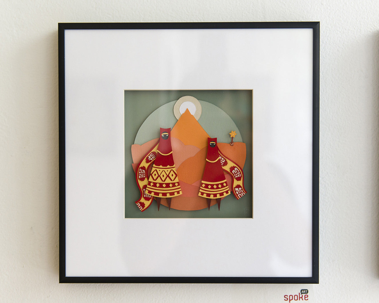 A unique paper collage by Meghan Stratman features two stylized figures adorned in red and orange patterns against a muted green circular background, showcasing geometric shapes and intricate detailing. An exquisite choice for your next art purchase.