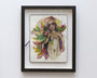This framed Original Art piece by Tatiana Suarez features a stylized female figure with vibrant leaves and floral elements in her hair and around her body, using soft, blended colors and metallic paint for a whimsical, ethereal touch.