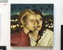 A framed oil on canvas by Michael Ramstead shows two apprehensive women close together, gazing forward with a backdrop of blurred city lights and palm trees, perfect for art enthusiasts seeking a unique piece.