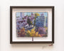 Laura Bifanos framed artwork captures a cityscape with trees, houses, and tall buildings in gouache. Its displayed in a dark wood frame alongside a Moleskine sketch detailing the gallery information.