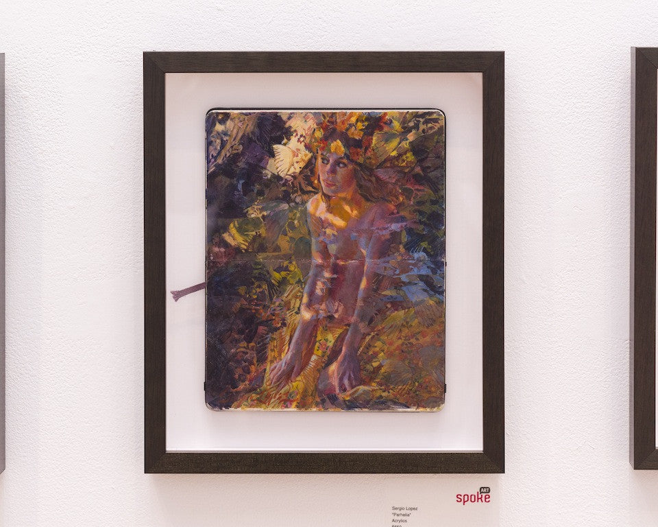 Enhance your space with a Sergio Lopez Art framed painting, featuring an abstract figure with long hair amid vibrant, leaf-like patterns. Set against a stark white wall, this piece is elegantly displayed in a sleek black frame.