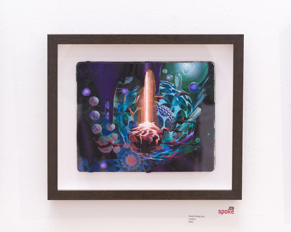 Framed artwork by David Chong Lee, showcasing an abstract, colorful cosmic scene with planets and a dynamic light beam. Positioned on a white wall with a small plaque, its part of the Untitled art collection at Spoke Art Gallery, featuring the spoke logo in the corner.