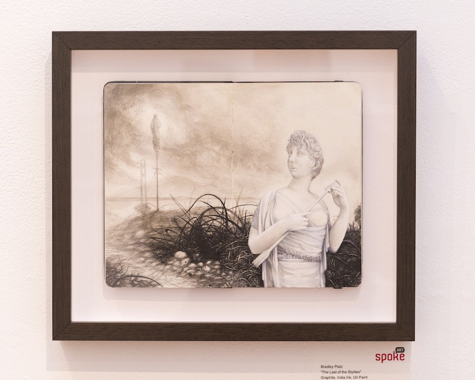 Bradley Platzs graphite drawing, The Last of the Stylites, depicts a figure in a classical robe holding a tool amidst wires with an ominous silhouette. This framed piece is mounted on a gallery wall and available for sale.