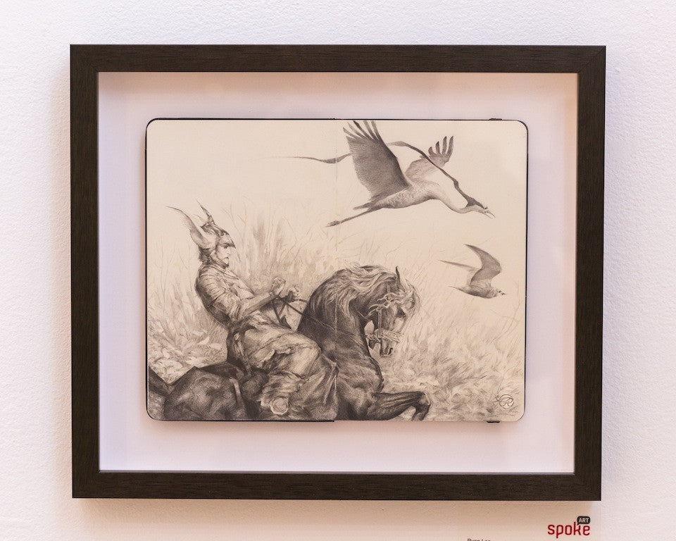 Framed pencil sketch by Ryan A. Lee depicts a dynamic scene of an armored rider on horseback with a spear, interacting with birds flying above, capturing the spirit of Cheval de Bataille.