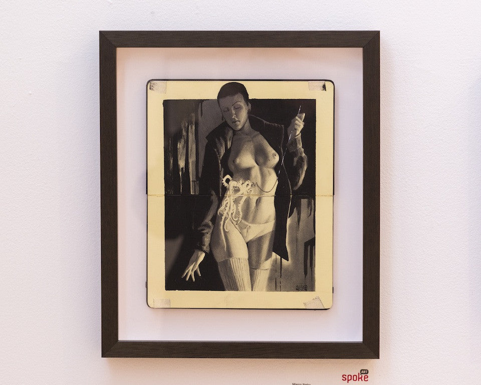 Art print by Marco Nelor showcases a monochrome sketch of a partially dressed woman with a coat and knife against a dark background, blending pencil and ink for vintage vibes, elegantly framed in dark wood.