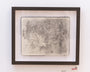 Framed artwork by Alex R. Kirzhner showcasing intricate graphite sketches of overlapping faces and abstract patterns on a two-page spread of an open Moleskine notebook, set against a white background, highlighting detailed textures and shading.