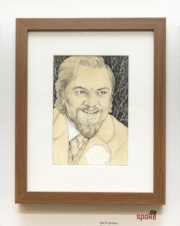 Framed artwork by Alex R. Kirzhner featuring a bearded man in a suit and tie grinning against a textured dark background. The wooden frame enhances the piece, which is signed in the bottom right corner.