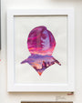 A gouache painting by Veronica Fish displays a silhouetted woman filled with a sunset over mountains. Below, a figure sits on a hill admiring the view. It comes signed and framed for gallery display.