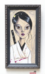 The painting, inspired by Sandi Calistros style, depicts a black-haired woman with large eyes in a white kimono with subtle bloodstains, resembling O-Ren Ishii. She stands poised with a sword on her back against a patterned backdrop, enclosed in an ornate dark frame.