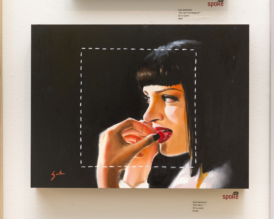 An oil on panel painting by Kate Zambrano showcases a woman with short black hair and red lipstick, surrounded by a white dotted square. She is depicted in profile, biting her thumb with a focused expression, displayed on a gallery wall.