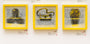 Three artworks hang on a wall, each with a yellow frame: the first features a dark angular shape, the second shows an abstract face with a hat, and the third resembles an abstract coffin shape. All evoke Derek Ballards style with their vivid yellow backgrounds.