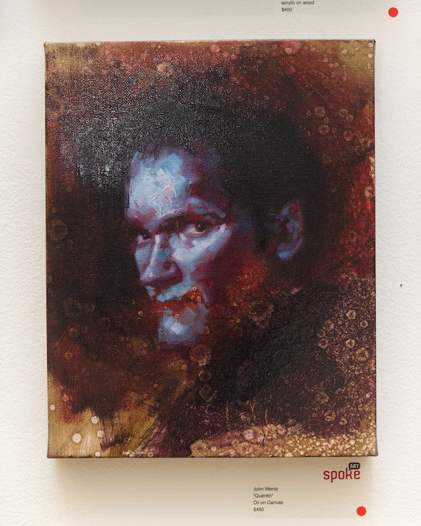 Quentin vs Coen, an oil on canvas by John Wentz, showcased at Spoke Art, depicts a mans face with vibrant blue and red hues against a textured backdrop, creating a mysterious abstract allure.