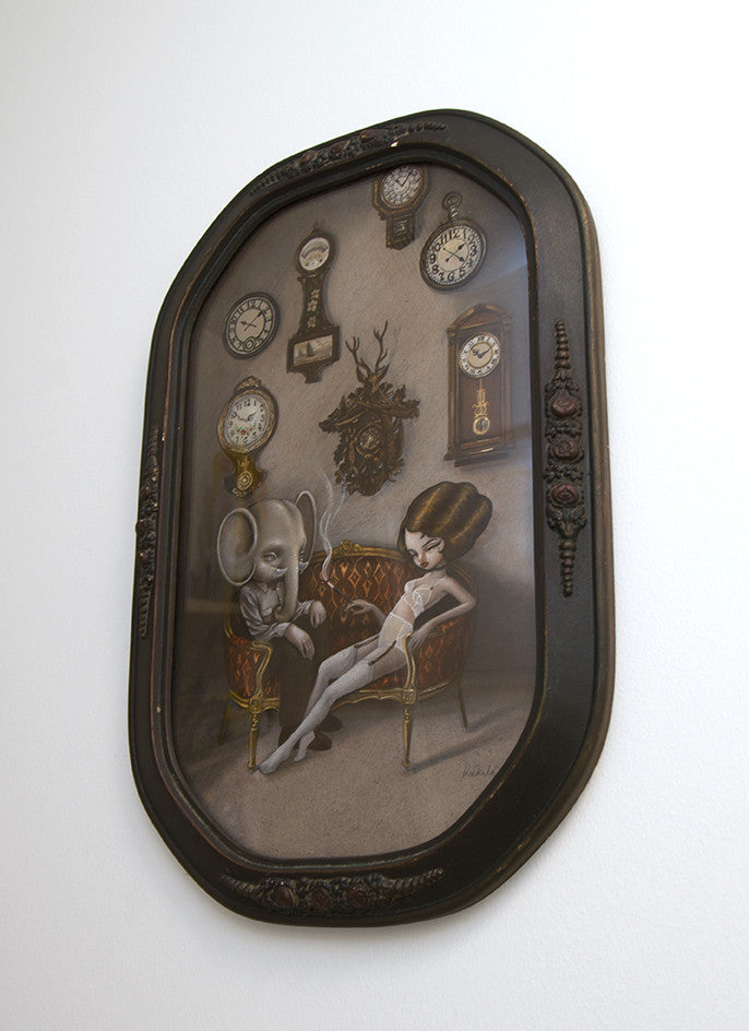 A framed Kukula art painting shows a surreal scene: a woman in white lingerie sits on a vintage chair next to an elephant-headed humanoid, surrounded by antique clocks, all beautifully rendered in oil on MDF.