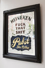 A framed mirror sign featuring decorative elements and mixed media artistry boldly displays: Ken Davis, Fuck That Shit, Pabst Blue Ribbon.