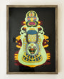 Daniel Jaffes framed abstract artwork features a complex, symmetrical design with vibrant colors. The layered paper art depicts face-like shapes with multiple eyes and mouths in green, yellow, blue, and red hues on a dark background.